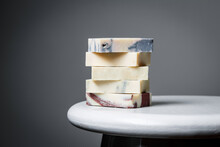 Natural Handmade Soap Bars With Different Ingredients On A White Wooden Background.
