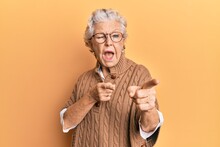 Senior Grey-haired Woman Wearing Casual Clothes And Glasses Pointing Fingers To Camera With Happy And Funny Face. Good Energy And Vibes.