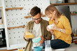 © JustLife - Young couple eating breakfast at home. Loving couple enjoying in the kitchen.