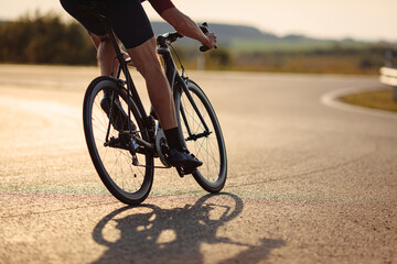 Wall Mural - Close up of road cyclist with strong legs biking outdoor