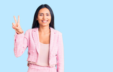 Young beautiful latin girl wearing business clothes showing and pointing up with fingers number two while smiling confident and happy.