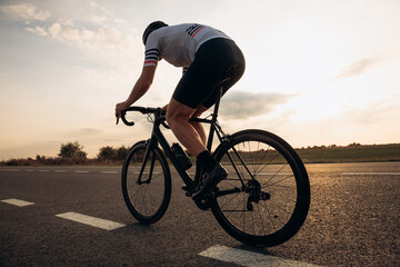 Wall Mural - Muscular man in helmet riding bike in half bent position