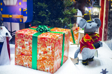 Wall Mural - Christmas toy mouse, a symbol of the Chinese New Year. soft toy mouse stands near a gift bag