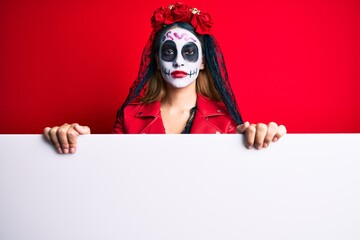 Sticker - Woman wearing day of the dead costume holding blank empty banner thinking attitude and sober expression looking self confident