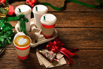 Wall Mural - Cup of coffee with christmas decorations on old wooden table