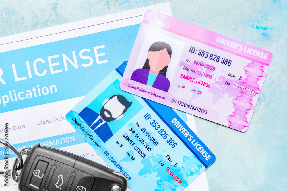 Driving licenses with application form and car key on color background