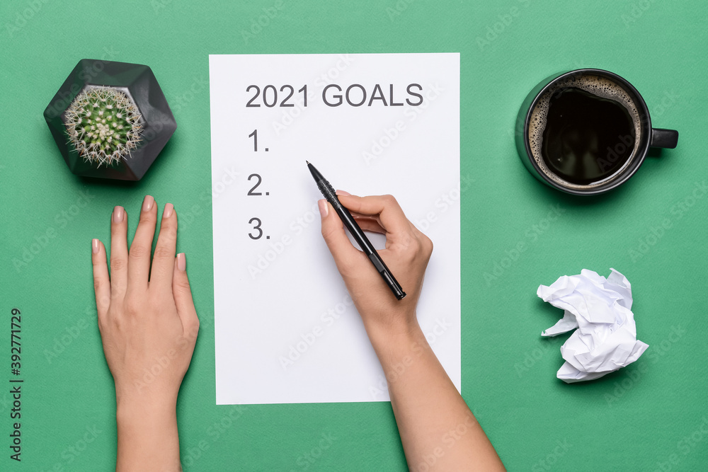 Woman making to do list on 2021 year, top view