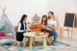 © Pixel-Shot - Female psychologist working with family at home