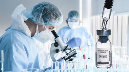 Wall Mural - coronavirus covid-19 vaccine bottle on background of research laboratory