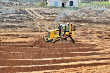 bulldozer on construction site job of burying the old building