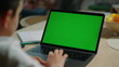 © stockbusters - Unknown boy using mockup computer home. Schoolboy looking laptop green screen