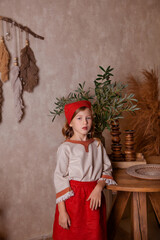 Wall Mural - little girl in a light linen shirt and a red scarf in a rustic style