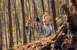 © Zoran Zeremski - Three female friends having fun and enjoying hiking in forest on a beautiful autumn day.