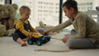 © stockbusters - Nice kids sharing toy cars on carpet. Amazing kids playing together indoors.