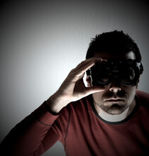 Dark Man With Black Goggles Looking At Camera.