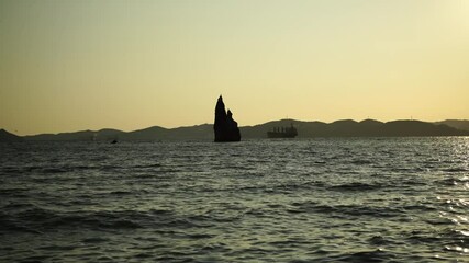 Wall Mural - Seascape with a rock silhouette on the horizon. Beauty of nature