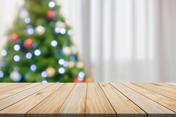 Empty table top with blurred Christmas tree with bokeh light background