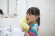 © M-image - young girl washing face by herself  in bathroom