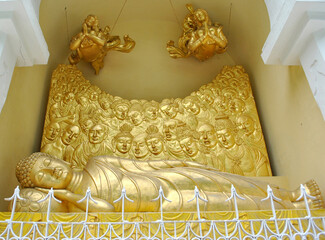 Golden statue of Sleeping Lord Buddha perched at Japanese Temple near Peace Pagoda in Darjeeling, India. It was built by M. Ohka in 1972 for world peace and serenity.