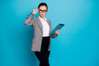 © deagreez - Portrait of attractive clever elegant lady specialist touching specs using device isolated on bright blue color background