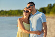 © Syda Productions - leisure, relationships and people concept - happy couple in sunglasses hugging on summer beach