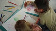 © stockbusters - Top view siblings coloring pictures home. Brother sister spending time together