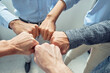 © Kostiantyn - Celebrating success. Close up shot of business people doing fists bump, while standing in the office