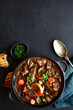 © lilechka75 - Beef bourguignon - meat stew with vegetables and mushrooms with red wine, traditinal dish of french cuisine. Top view with copy space.