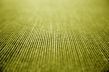 Wall Mural - Textile pattern close-up with blur defocused effect in yellow color.