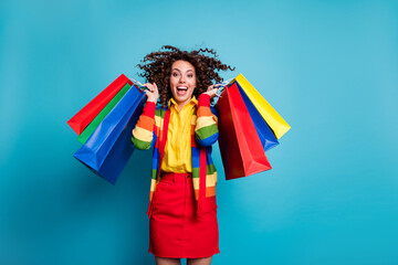 Canvas Print - Photo of beautiful trendy stylish brown wavy haired girl wear red skirt excited shopping raise bags isolated on blue color background