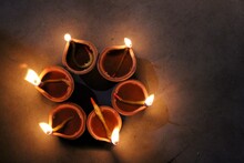Flickering Earthen Lamps With Lights On Deepawali