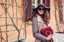 Portrait Of Stylish Young Woman Wearing Hat Coat Holding Handbag Outdoors. Autumn Fashion Female Retro Accessories