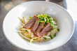 © D.APIWAT - Delicious Beef noodles with vegetables prepare for the cook in a dish. Concept: food arrangement and decoration.