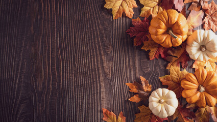 Wall Mural - thanksgiving background decoration from dry leaves and pumpkin on old wooden background. flat lay, t