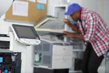 Male Technician Repairing Digital Photocopier Machine