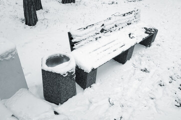 Wall Mural - Outdoor bench and trash can covered with snow