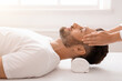 © Prostock-studio - Bearded man enjoying relaxing head massage at spa