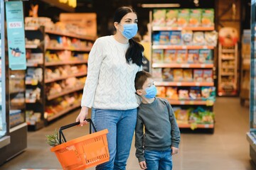 Wall Mural - Mother and son are shopping at the grocery store. They wear masks during quarantine. Coronavirus Pandemic .COVED-19 Flash. The epidemic of the virus