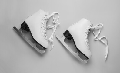 Wall Mural - pair of figure ice skates on light grey background, flat lay