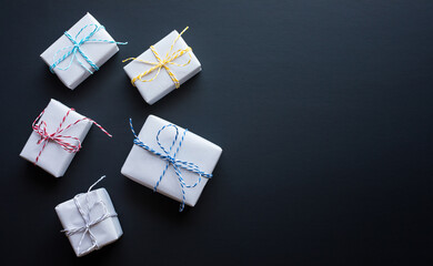 Wall Mural - white simple gift box in diy style on dark background.giving and anniversary cocepts idea