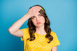 Frustrated tired girl touch forehead with hand look copyspace sigh wear yellow green clothes isolated on blue color background