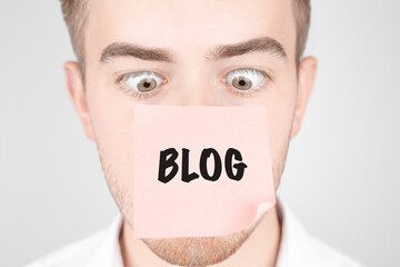 Poster - Man with a red sticker on his nose reads the text Blog
