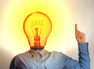 Concept of a new idea. A man with a light bulb instead of a head.