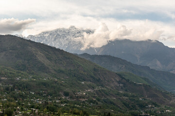 Wall Mural - A snow capped Himalayan mountain peak towering above the Himalayan village of Munsyari in Uttarakhand.