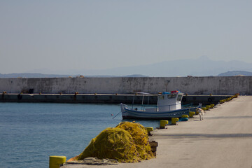 Blue and white fishing boat in harbor.