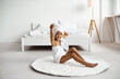 © jul14ka - Little girl wrapped in a towel after a shower sits on the carpet on the floor in the room.