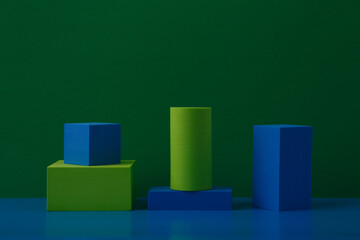 Wall Mural - Abstract background with green and blue solid figures on green and blue background with a space for text. Concept of minimalism and simplicity