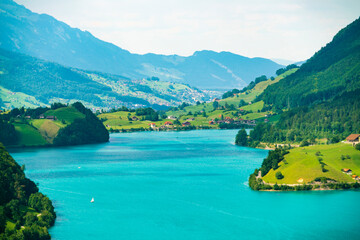 Lungern lake overview in summer with the Alps mountains in the backgro