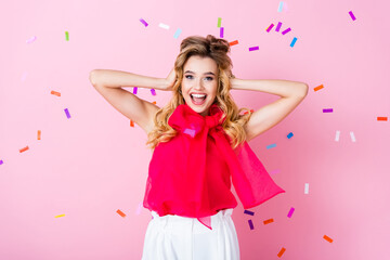 Wall Mural - happy woman on pink background with falling confetti