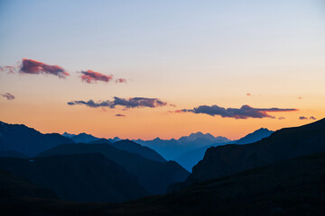 Wall Mural - colorful dawn landscape with beautiful mountains silhouettes and golden gradient sky with lilac clou